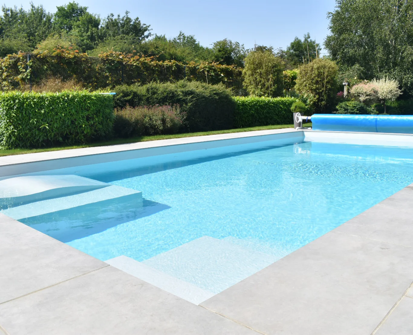 Outdoor pool with automatic cover and modern patio