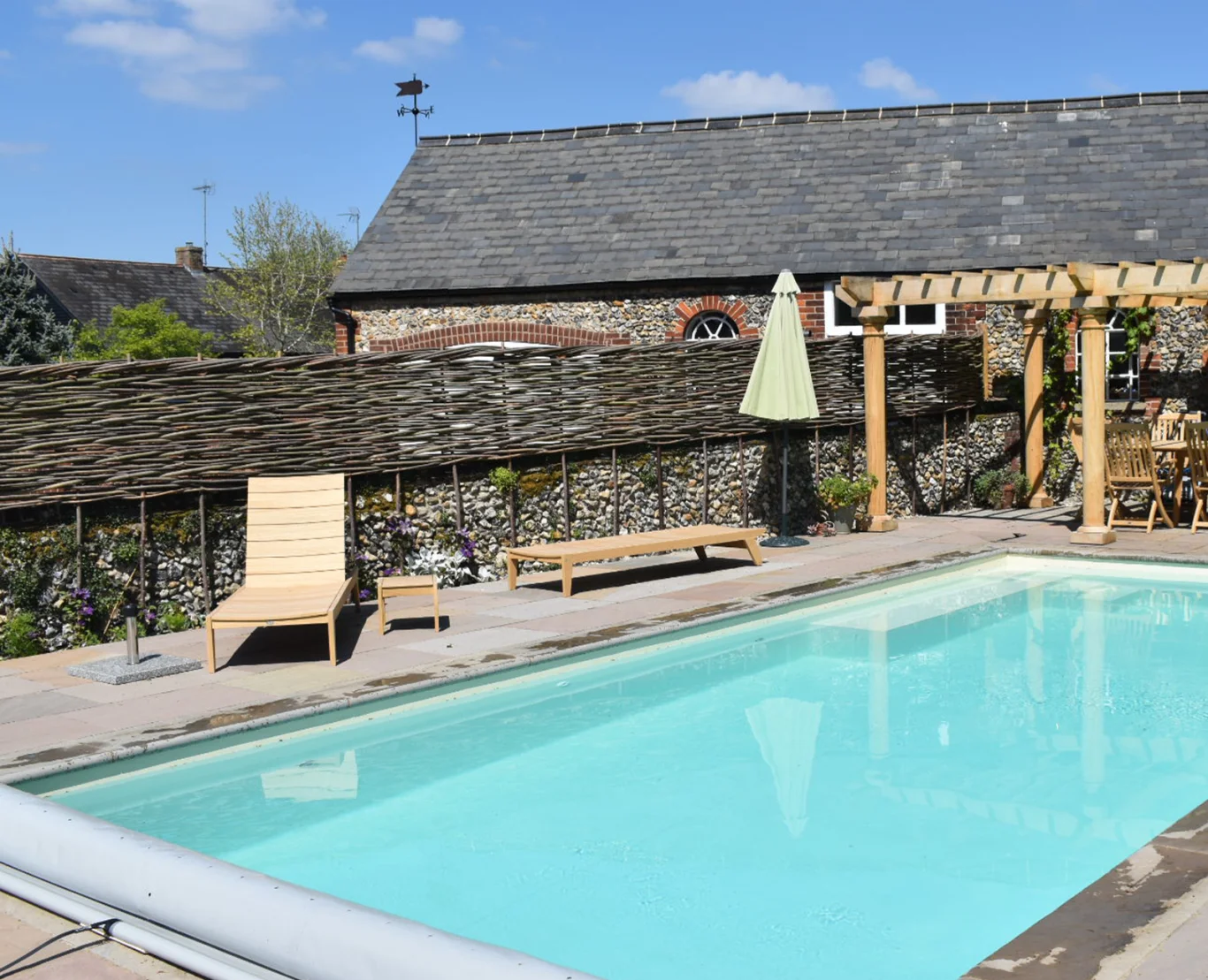 Outdoor swimming pool installation in an established garden