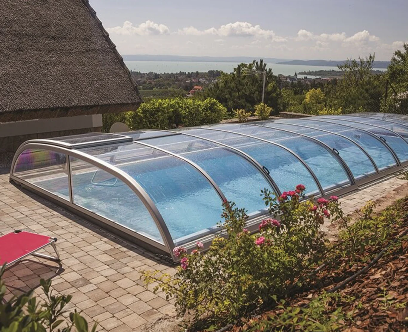 Glazed pool enclosure protecting an outdoor swimming pool